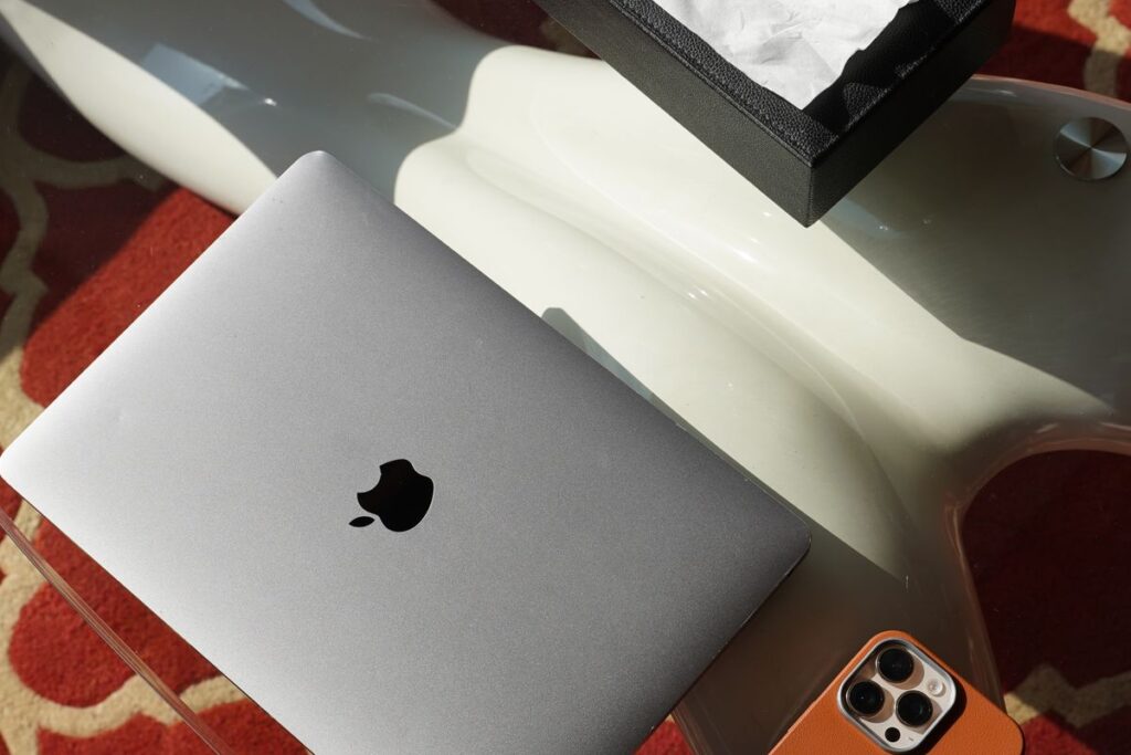 The Hidden Cost of Multitasking (And What to Do Instead) Bright modern desk workspace with a laptop and smartphone side by side