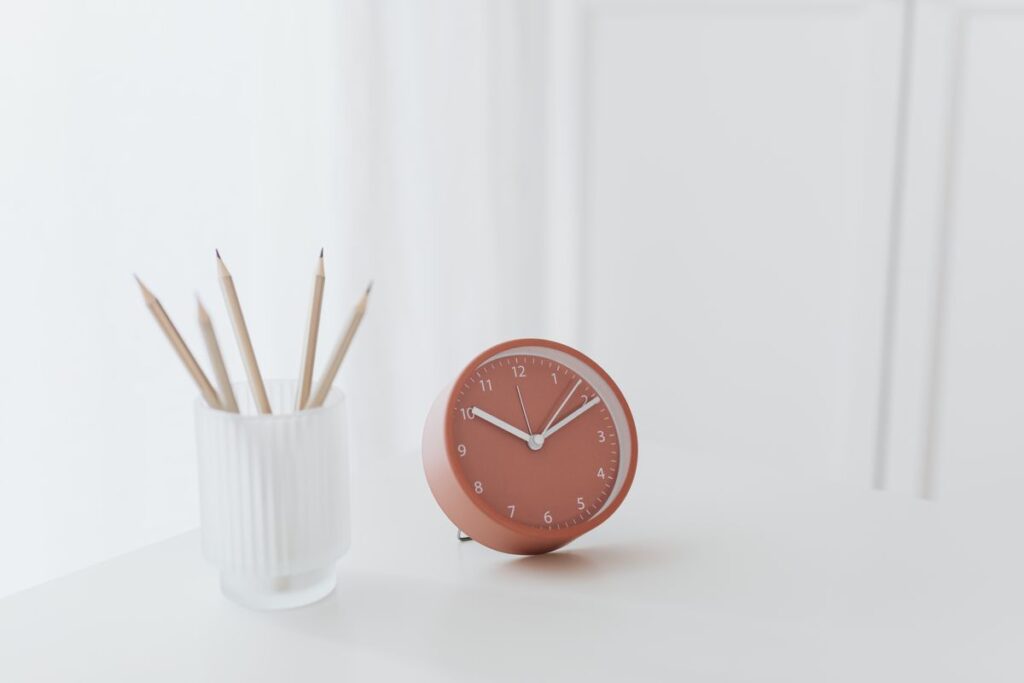 The Five-Minute Rule: How to Beat Procrastination Before It Starts Clock and pencils on a desk, symbolizing time and focus