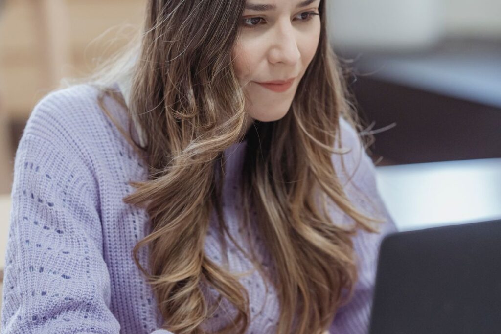 Radiate, Don’t Just React: The Difference Between Busy and Effective Focused woman calmly working on her laptop